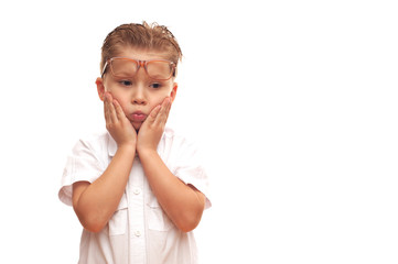 Little handsome pensive child in a shirt and glasses