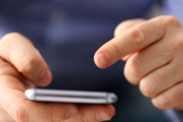 Businessman arm using modern cell phone closeup