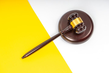 Gavel hammer with yellow background