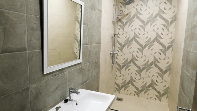Interior of a modern, beautiful, small bathroom in beige tones. Picture of shower cubicle in modern toilet, small apartments design concept.