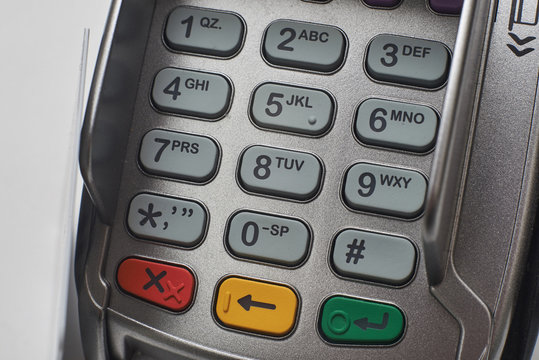 Credit card reader on white table background.