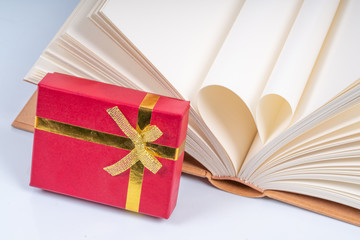 Book and red box gift with educational concept