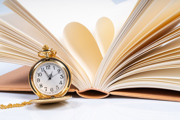 Book and pocket watch with educational concept