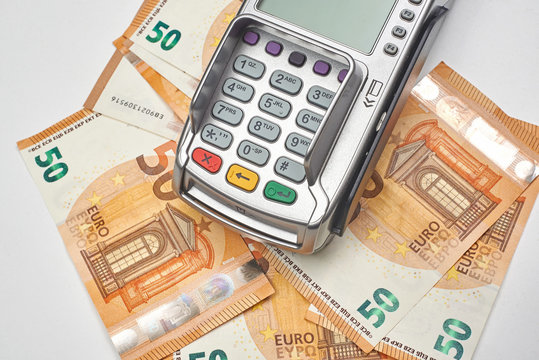 Credit card reader on money background.