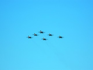 A group of military aircraft flies in formation at air shows