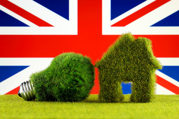 Green eco light bulb, eco house icon and United Kingdom Flag. Renewable energy. Electricity prices, energy saving in the household.