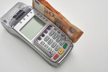 Credit card reader with money.Electronic money and cash.