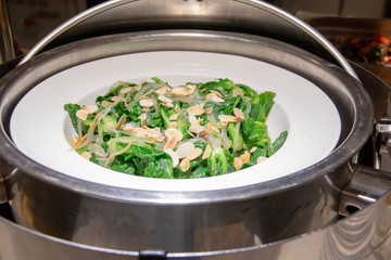 boile spinach with butter in white plate