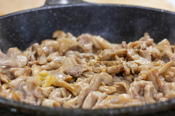 The process of frying chicken fillet in a pan