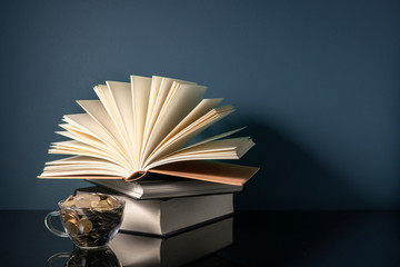 Coins cup and stalking books with low light
