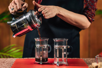 French Press Coffee. Barista Pouring French Press Coffee