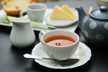 Tea served with cream, butter and a cake