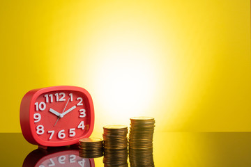 Clock and coins with yellow background