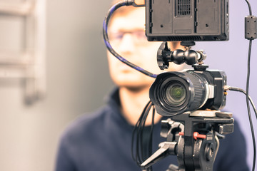 Professional film camera on a tripod in broadcasting studio