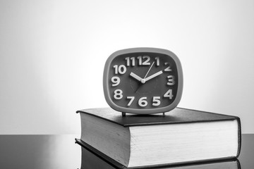 Clock and book with yellow background