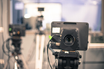 Film camera in broadcasting studio, spotlights and other equipment