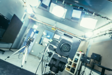 Film camera in broadcasting studio, spotlights and other equipment