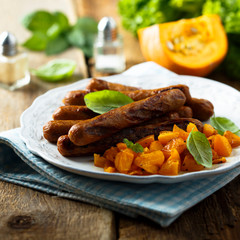 Grilled sausages with roasted pumpkin