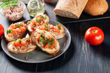 Appetizer bruschetta with tuna, mozarella cheese and tomatoes