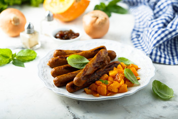 Grilled sausages with roasted pumpkin