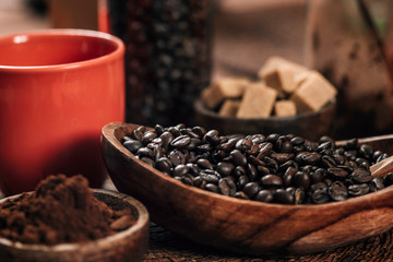 Red Coffee Cup, Coffee Beans And Ground Coffee In Wooden Bowl