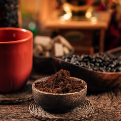 Ground Coffee In Wooden Bowl On Table