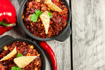 Bowls of hot chili con carne with ground beef, beans, tomatoes a