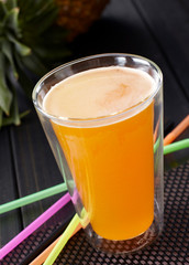 Delicious drink, pineapple juice. On wooden table
