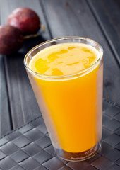 Delicious drink, passion fruit juice. On wooden table