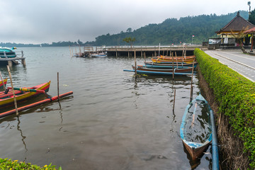 BALI, INDONESIA - SEPTEMBER 25, 2017: Traditional wooden boat at lake temple.