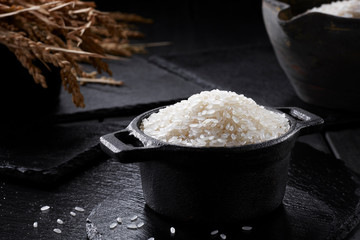 White steamed rice in black round pot
