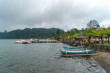 Traditional wooden boat with cloudy skies.