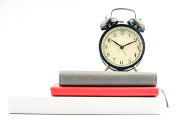 Clock and book with white background.