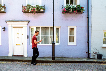 Man walking by beautiful multicolored houses facades