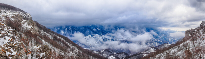 Fototapeta na wymiar Winter mountains panorama with dynamic clouds. Aerial panorama landscape of Dry mountain, Serbia