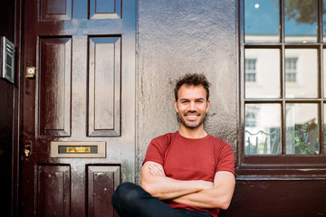 Man sitting in a bench on a beautiful maroon background