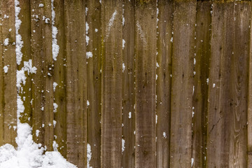 old wooden fence in the snow