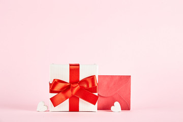 Happy Valentine's day concept. Close up composition with presents wrapped in colorful paper and tied with satin bow, traditional lovers day holiday attributes. Copy space, background, top view.