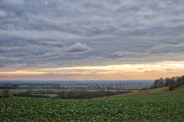 Plakat View from Langdon Hills, Essex. Looking across South Essex towards the Thames Estuary with Kent in the distance. Beautiful cloud formations over green fields and trees.