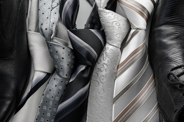 Set of colorful men's ties isolated on dark background.
