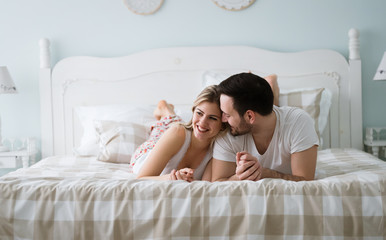 Obraz na płótnie Canvas Portrait of young loving couple in bedroom