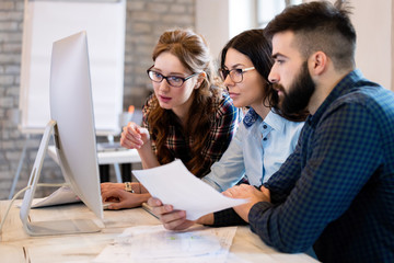 Young architects working on project in office