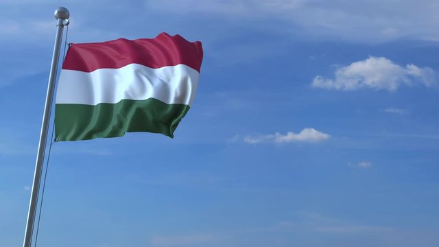 Commercial airplane landing behind waving Hungarian flag. Travel to Hungary conceptual animation