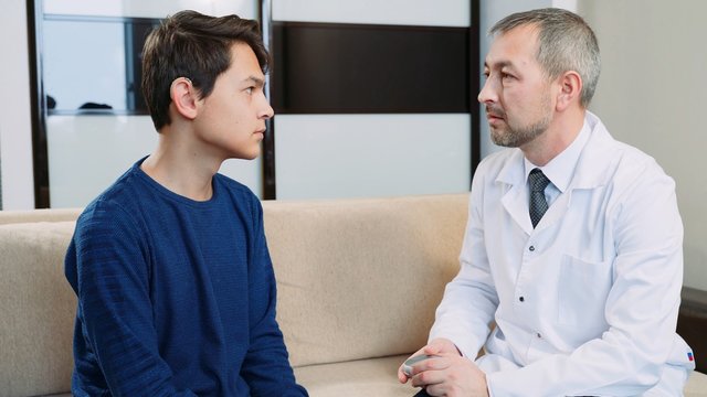 Hearing Impaired Young Man At The Doctor's Office.