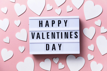 Happy Valentin's Day lightbox message with white hearts on a pink background