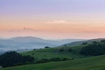 Fototapeta premium Romantic, bright and colorful sunset over a mountain range in Transylvania. Beautiful, colorful autumn background. 