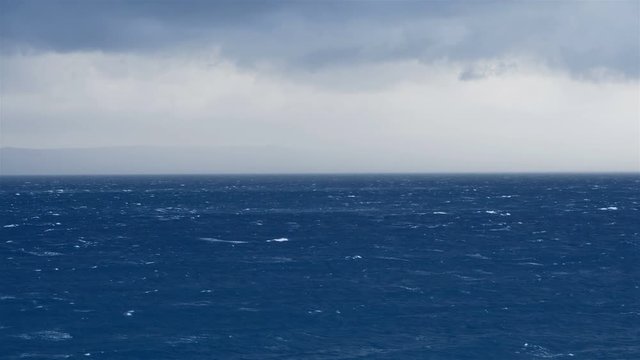 Landscape scene fof strong wind on blue sea and moving clouds above