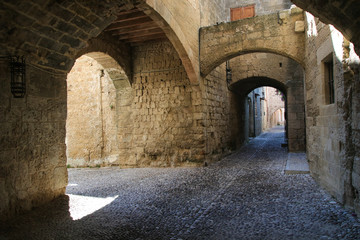 Fototapeta na wymiar Medieval arched street in the town of Rhodes