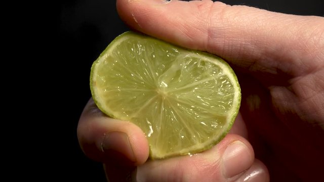 Hand squeeze a fresh  lime