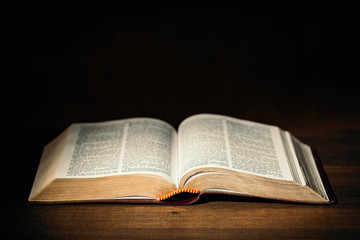 Holy Bible in the dark on a pastors desk